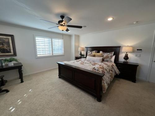 a bedroom with a bed and a ceiling fan at Amazing Large Family Home w/Pool, 1 Mile to Disney in Anaheim
