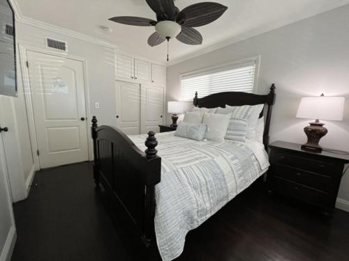 a bedroom with a bed with a ceiling fan at Gorgeous Pool Home 1/2 Mile Walk to Disney in Anaheim