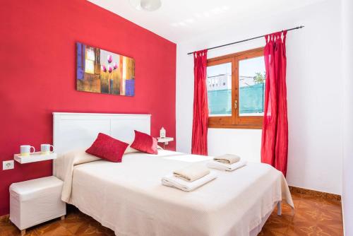 a red bedroom with two beds and a window at Villa Dulcesol by Villa Select in Alaior
