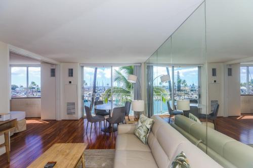 a living room with a couch and a dining room at Ilikai Marina 382 in Honolulu
