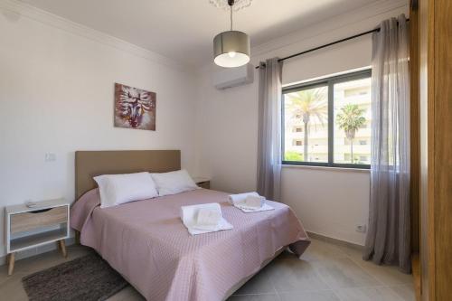 a bedroom with a bed with two towels on it at Villa Miramar Gale by Villa Select in Galé