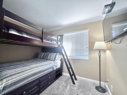 a bedroom with bunk beds and a lamp in it at Luxurious 2 Bedroom Condo Shortest Walk To Disney in Anaheim