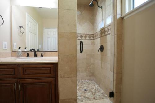 a bathroom with a shower and a sink at Charming Anaheim Home 1/2 Mile Walk to Disney in Anaheim