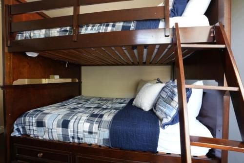 a couple of bunk beds with a bed in a room at Charming Anaheim Home 1/2 Mile Walk to Disney in Anaheim