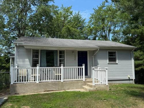a small white house with a white fence at The Vineyard House | Spacious Home Near Wine, Beer & Lake MI in Bridgman