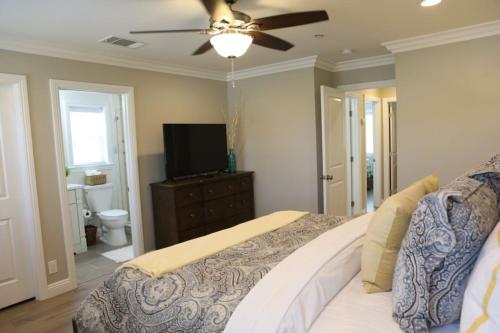 a bedroom with a bed and a ceiling fan at Adorable 3 Bedroom 2 Bath Home in Fullerton