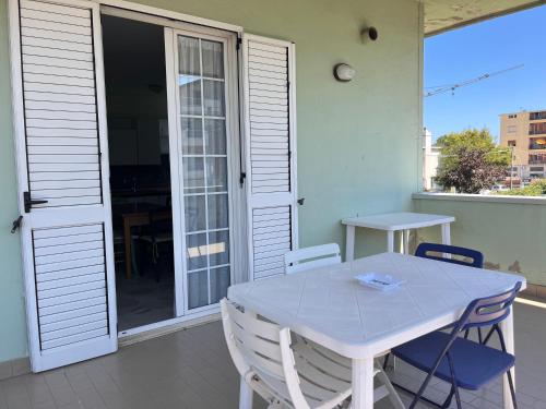 a white table and chairs on a balcony at Appartamento Arena by OTIUM in Giulianova