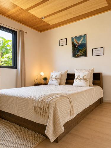 a bedroom with a large bed and a window at L'Escapade Volcanique in Sainte-Rose
