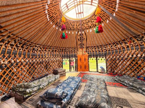 a large room with beds in a yurt at Kyrgyz Yurt Camp in Mineralʼnyy Istochnik Altyn-Arasan