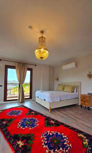 a bedroom with a bed and a red rug at Bozburunvillas in Bozburun