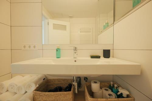 a bathroom with a sink and a mirror and towels at Rutlla 10 in Girona