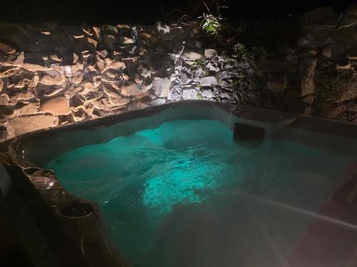 an overhead view of a swimming pool at night at Butterlump Cottage in Glastry