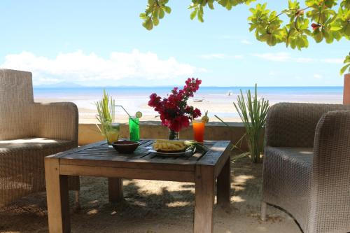 a table with a tray of food on a beach at Nosy Lodge in Nosy Be