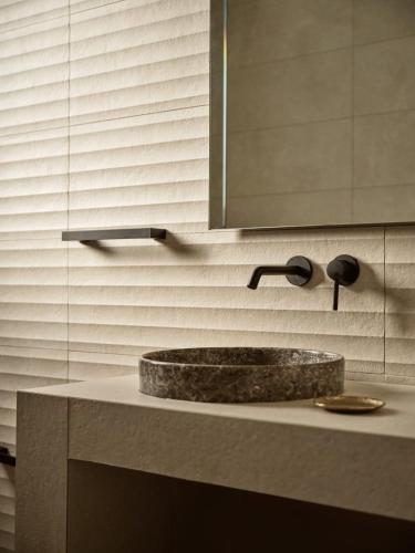 a bathroom counter with a sink and a mirror at Villa Theta by Villa Select in Kalamaki