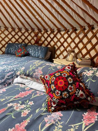 two beds in a yurt with pillows on them at Oakdean Cottage Yurt in Blakeney