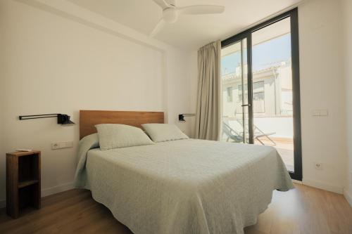 a bedroom with a bed and a large window at Rutlla 10 in Girona