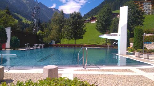 a large swimming pool with a mountain in the background at Ferienhaus Unterbrunnhaus in Finkenberg