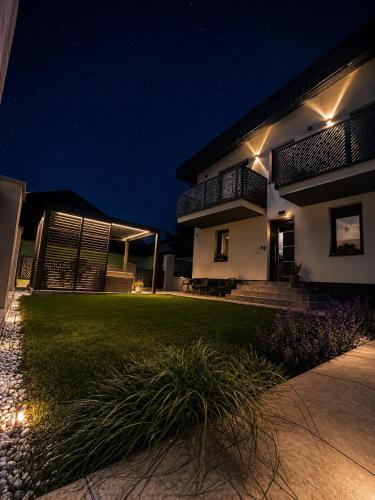 a house at night with lights on the lawn at Apartmány TAMKA in Vrbov