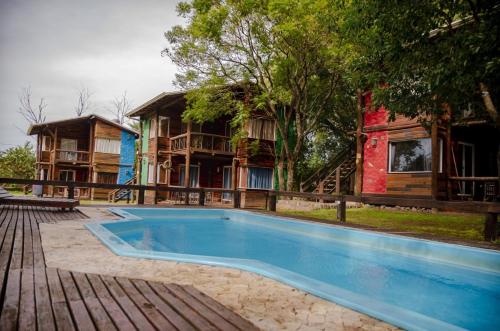 a swimming pool in front of a house at Posada La Solana in El Cadillal