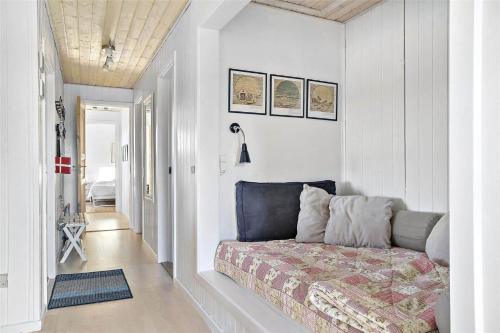 a bedroom with a bed in the corner of a room at LN1094-Hirtshals-Strandklitten-2 in Hirtshals