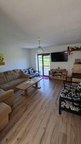 a living room with a couch and a table at Chata Chotár Nová Baňa in Veľká Lehota
