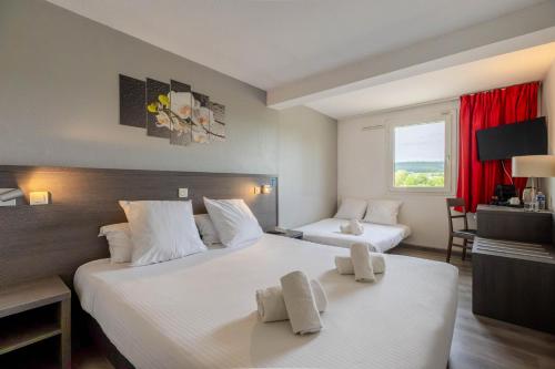 a hotel room with two beds and a window at TheOriginals City, Hôtel restaurant l'Ormichal Dijon Sud in Marsannay-la-Côte