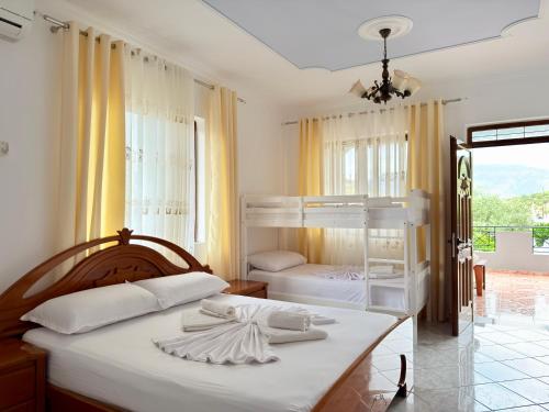 a bedroom with two bunk beds and a balcony at Villa Reshat Caca in Ksamil