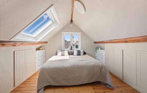 a attic bedroom with a bed and a window at Large & Cozy Stavanger Apt in Stavanger