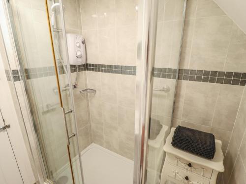 a bathroom with a shower with a glass door at Sandringham in Withernsea