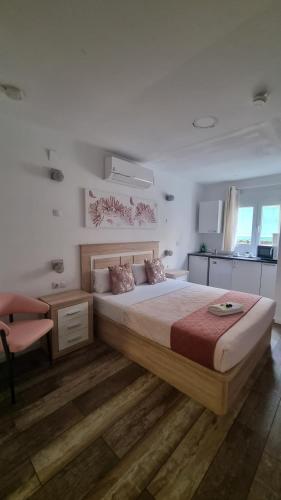 a bedroom with a large bed and a chair at hostal olozaga in Alicante