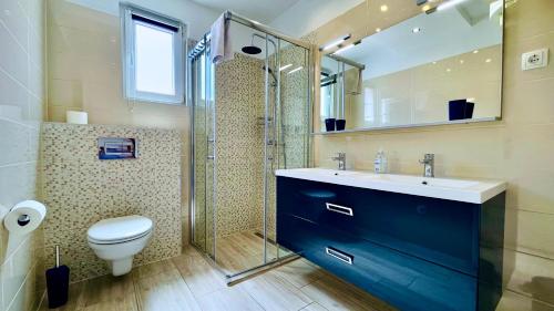 a bathroom with a toilet and a sink and a shower at Marevista in Dramalj
