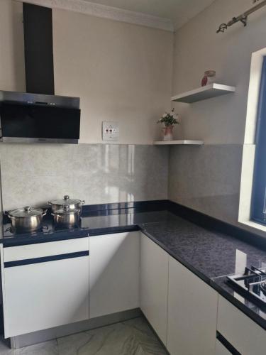 a kitchen with two pots on a stove at Cosy Corner Villa in Lusaka