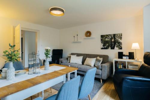 a living room with a table and a couch at Hof Timmermann - Landhaus, oben in Ottenstein