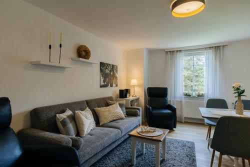 a living room with a couch and a table at Hof Timmermann - Landhaus, oben in Ottenstein