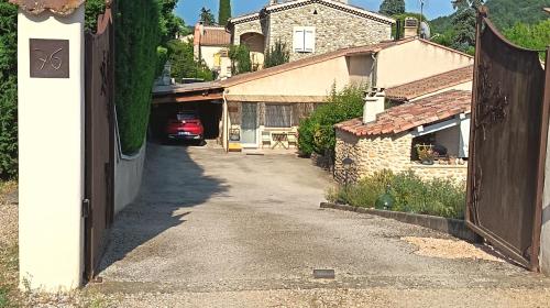 an alley in a house with a car on a driveway at La ruchette in Riez