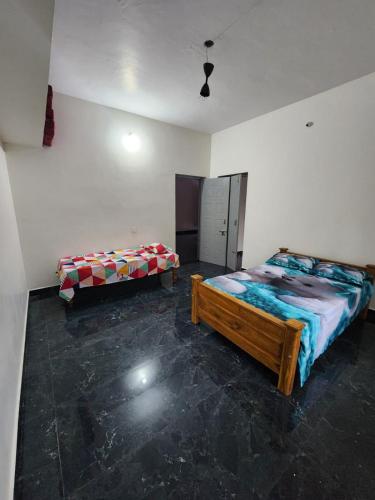 a bedroom with two beds in a room at Shrunga Shreni Homestay - Near Bandaje trek and falls in Kalasa
