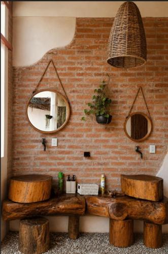 a bathroom with a wooden bench and a mirror at Domo Abitare Glamping in Isla de Mezcala