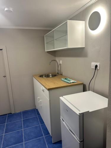 a small kitchen with a sink and a counter at Nia The Yard in Nafpaktos