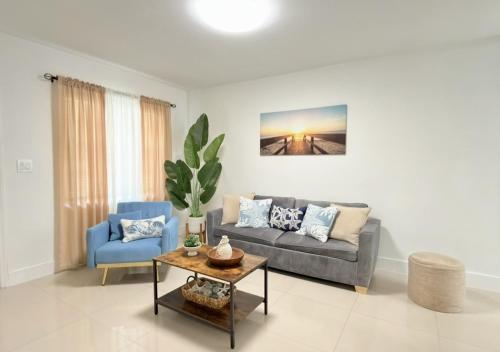 a living room with a couch and a table at Miami Blue Oasis l 2BR with free parking in Miami