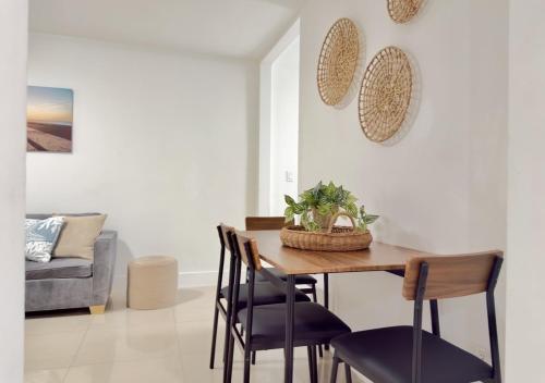 a dining room with a table and chairs at Miami Blue Oasis l 2BR with free parking in Miami