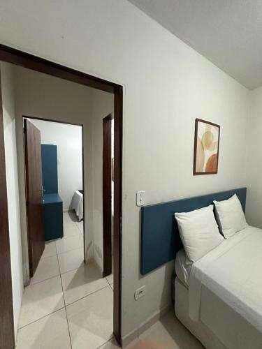 a bedroom with a large bed and a mirror at Pousada Caribe Brasileiro in Maragogi
