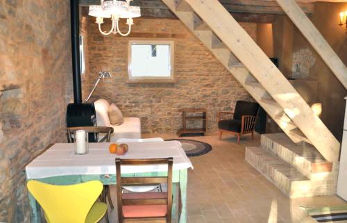 a room with a staircase and a table and chairs at Borgo Farneto in Montecarotto