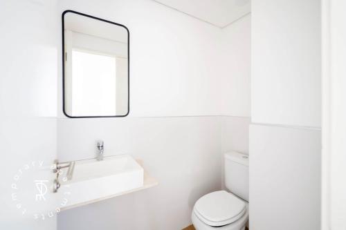 a white bathroom with a sink and a mirror at Top Rentals Palermo Chico in Buenos Aires