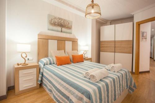 a bedroom with a bed with towels on it at Castillo Buenavista in Ponferrada