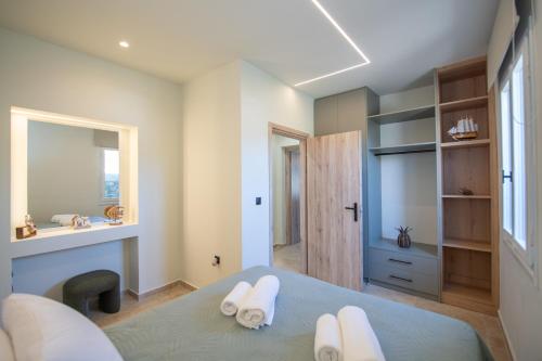a bedroom with a bed with white towels on it at MARIA'S Roof Top View in Poros