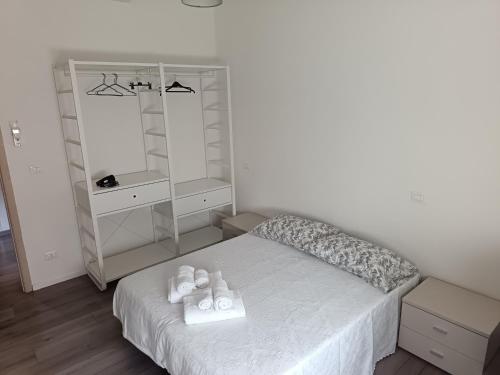 a bedroom with a bed with a dresser and a mirror at B&B Villa AVE in Seriate