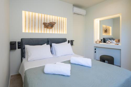 a bedroom with a bed with two white pillows at MARIA'S Roof Top View in Poros