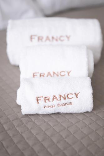 a stack of towels with the words fridayancyancy and song on them at B&B Francy and sons in Modugno