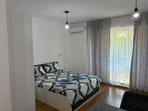 a bedroom with a bed and a large window at Studio ANA Saturn 1 in Saturn