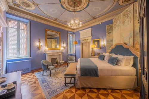 a bedroom with a king sized bed and a fireplace at Palazzo Trezza in Verona